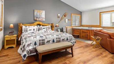 a bedroom with a bed and a desk and a couch at Mountain Shadows Resort in Estes Park