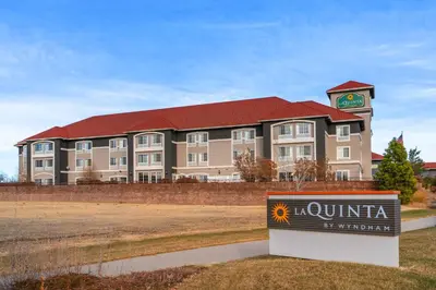 a hotel with a sign in front of a building at La Quinta Inn & Suites by Wyndham Loveland Estes Park in Loveland
