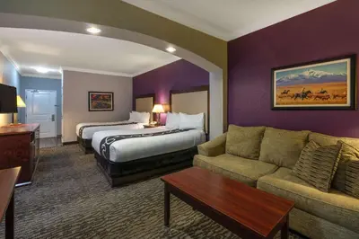 a hotel room with a bed and a couch at La Quinta Inn & Suites by Wyndham Loveland Estes Park in Loveland