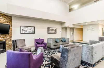 a waiting room with chairs and a flat screen tv at Quality Inn & Suites Westminster - Broomfield in Westminster