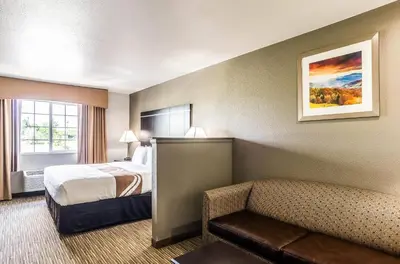 a hotel room with a bed and a couch at Quality Inn & Suites Westminster - Broomfield in Westminster