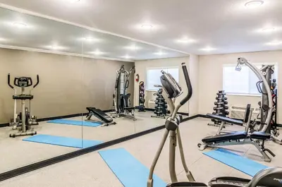 a gym with tread machines and a mirror at Quality Inn & Suites Westminster - Broomfield in Westminster