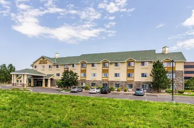 a large building with cars parked in a parking lot at Quality Inn & Suites Westminster - Broomfield in Westminster