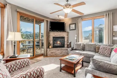 a living room with a couch and a fireplace at Mount Cirrus 10B Condo in Estes Park