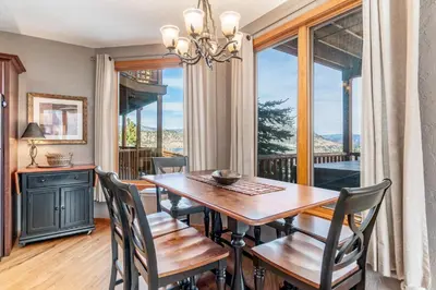 a dining room with a table and chairs and a window at Mount Cirrus 10B Condo in Estes Park