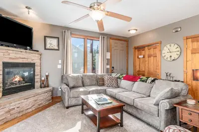 a living room with a couch and a fireplace at Mount Cirrus 10B Condo in Estes Park