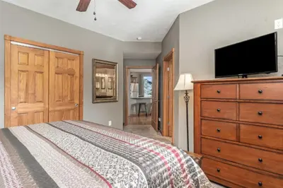 a bedroom with a bed and a flat screen tv at Mount Cirrus 10B Condo in Estes Park