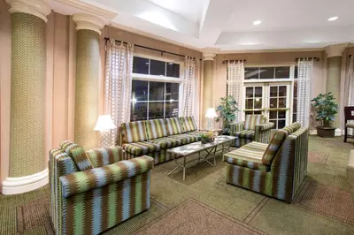 a living room with couches and chairs and a table at La Quinta by Wyndham Denver Southwest Lakewood in Lakewood