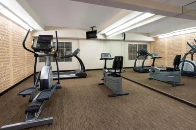 a gym with treadmills and elliptical machines at La Quinta by Wyndham Denver Southwest Lakewood in Lakewood