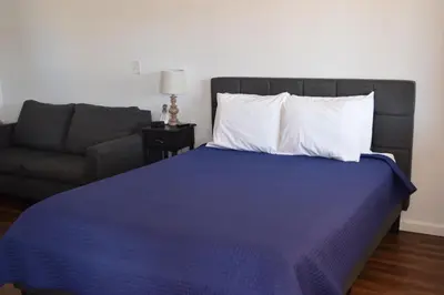 a bedroom with a bed and a couch at Stone Mountain Lodge in Lyons