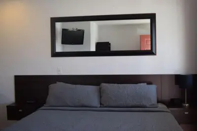 a mirror above a bed in a bedroom at Stone Mountain Lodge in Lyons