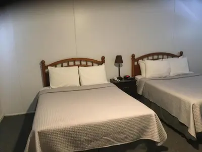 a hotel room with two beds with white sheets at Stone Mountain Lodge in Lyons
