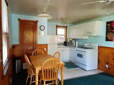 a kitchen with a table and chairs and a white stove at Stone Mountain Lodge in Lyons