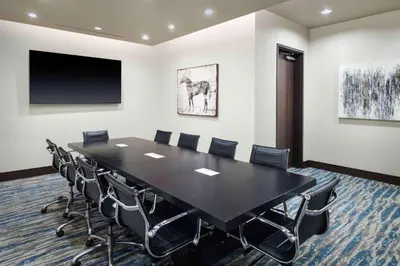 a conference room with a black table and chairs at Hampton Inn & Suites Denver Downtown Convention Center in Denver