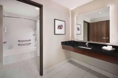 a bathroom with a sink and a shower at Homewood Suites- Denver Downtown Convention Center in Denver