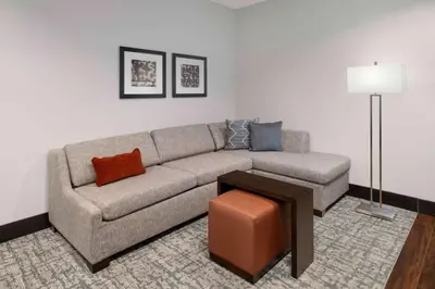a living room with a couch and a table at Homewood Suites- Denver Downtown Convention Center in Denver
