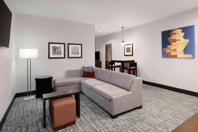 a living room with a couch and a table at Homewood Suites- Denver Downtown Convention Center in Denver