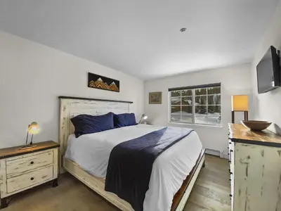 a bedroom with a large bed and a window at Swans Nest Villa 1601 Condo in Breckenridge