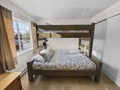 a bedroom with two bunk beds and a window at Swans Nest Villa 1601 Condo in Breckenridge