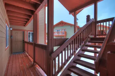 a wooden staircase leading to a porch of a house at Swans Nest Villa 1601 Condo in Breckenridge