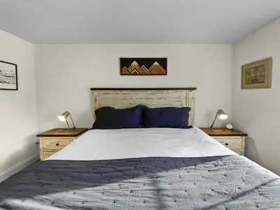 a bedroom with a large bed with two night stands at Swans Nest Villa 1601 Condo in Breckenridge