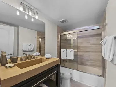 a bathroom with a wooden sink and a shower at Swans Nest Villa 1601 Condo in Breckenridge