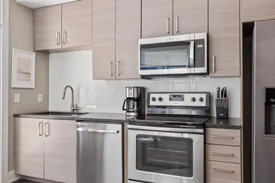a kitchen with stainless steel appliances and a microwave at Kasa Union Station Denver in Denver