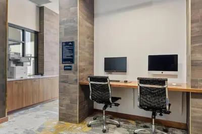 an office with two computer monitors on a desk with two chairs at Kasa Union Station Denver in Denver