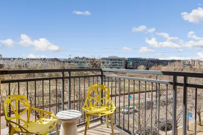 two yellow chairs on a balcony with a view at Kasa Union Station Denver in Denver