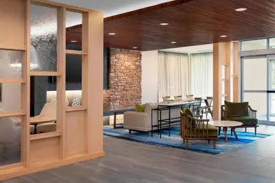 a lobby with a waiting area with chairs and a table at Fairfield Inn & Suites by Marriott Denver Tech Center North in Denver