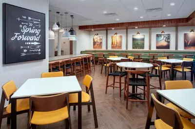 a restaurant with tables and chairs and a bar at Fairfield Inn & Suites by Marriott Denver Tech Center North in Denver