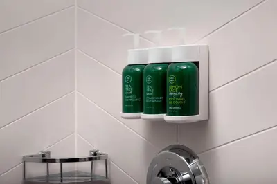a bathroom with two green bottles on a wall at Fairfield Inn & Suites by Marriott Denver Tech Center North in Denver