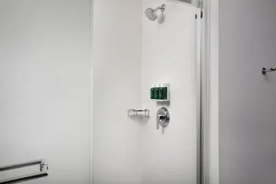 a shower in a bathroom with a glass door at Fairfield Inn & Suites by Marriott Denver Tech Center North in Denver