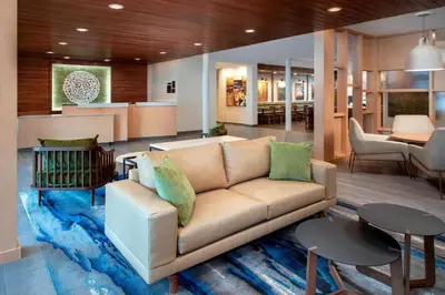 a living room with a couch and a table at Fairfield Inn & Suites by Marriott Denver Tech Center North in Denver