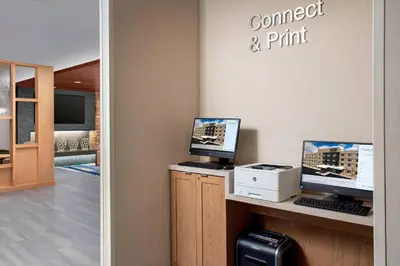 a room with two computer monitors on a counter at Fairfield Inn & Suites by Marriott Denver Tech Center North in Denver