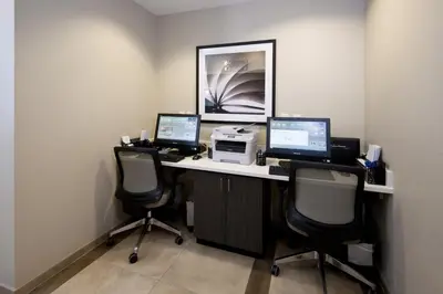 an office with three computers on a desk at Candlewood Suites Greeley by IHG in Greeley