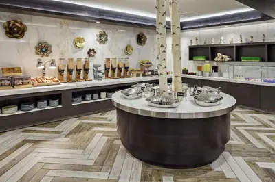a restaurant with a large round counter in a room at DoubleTree by Hilton Hotel Denver in Denver