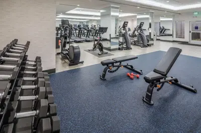 a gym with several treadmills and exercise bikes at DoubleTree by Hilton Hotel Denver in Denver