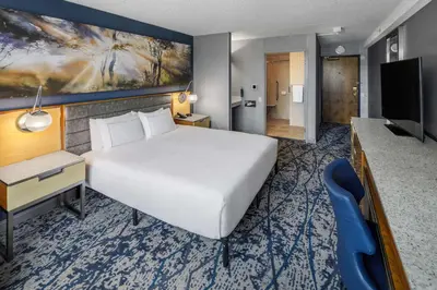 a hotel room with a large bed and a television at DoubleTree by Hilton Hotel Denver in Denver
