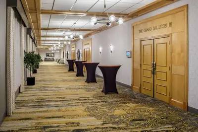 a hallway with a row of stools in a building at DoubleTree by Hilton Hotel Denver in Denver