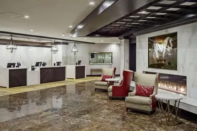 a waiting room with chairs and a fireplace at DoubleTree by Hilton Hotel Denver in Denver