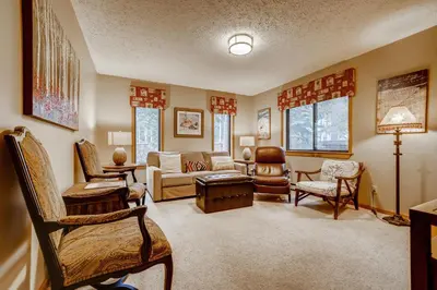 a living room filled with furniture and windows at Casa de Montagne Home: High-End Log Home, Downtown Frisco in Frisco