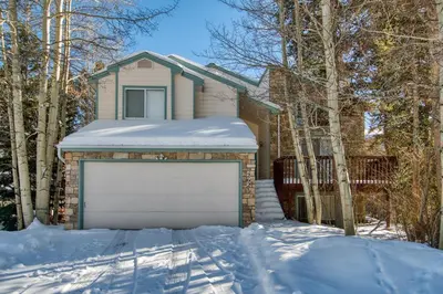 a house with a white garage in the snow at Solitude Station Home: Walk to Downtown in Frisco