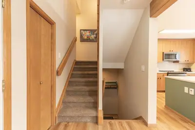 a staircase leading up to the kitchen in a house at Solitude Station Home: Walk to Downtown in Frisco