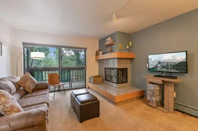a living room with a couch and a fireplace at Lagoon Royal Townhome: Mountain Views Meet Modern Comforts in Frisco