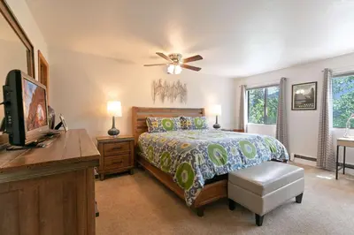 a bedroom with a bed and a ceiling fan at Lagoon Royal Townhome: Mountain Views Meet Modern Comforts in Frisco