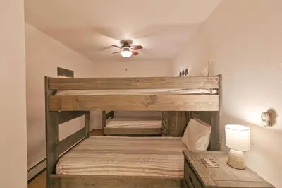 two bunk beds in a room with a ceiling at Lagoon Royal Townhome: Mountain Views Meet Modern Comforts in Frisco