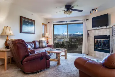 a living room with leather furniture and a fireplace at Lake Forest Shoreview Condo: Fantastic Views in Frisco