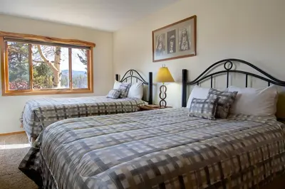 a bedroom with two beds and a window at Lake Forest Shoreview Condo: Fantastic Views in Frisco