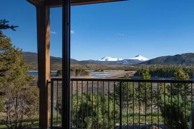 a view from the balcony of a lodge with snow covered mountains at Lake Forest Shoreview Condo: Fantastic Views in Frisco